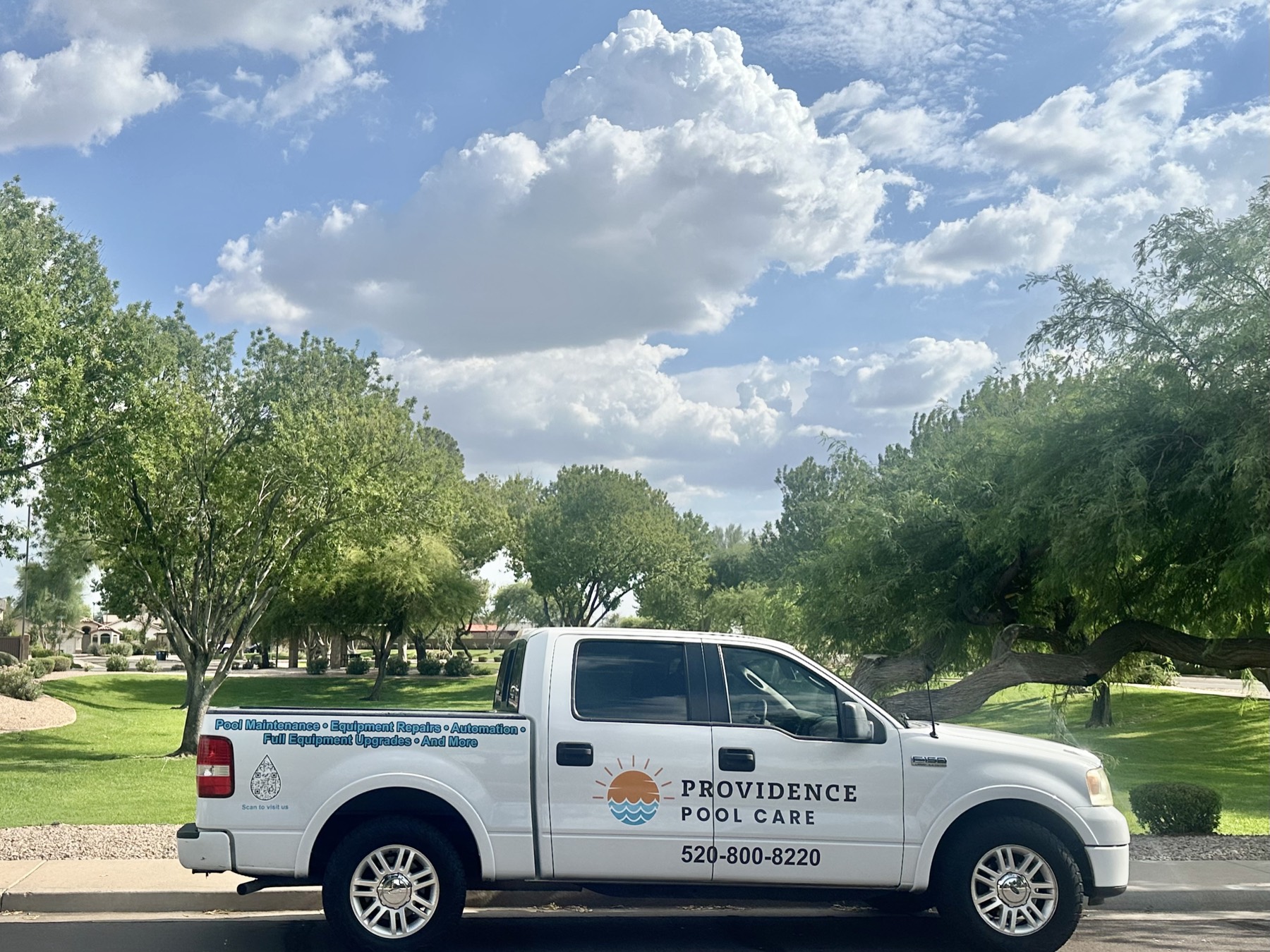 The branded Providence Pool Care truck parked on a tree-lined East Valley street